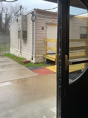 A view of a modular classroom from a school's exterior doorway